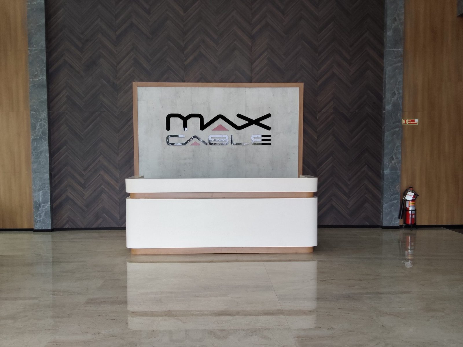 Max Cable acrylic logo mounted on reception backdrop