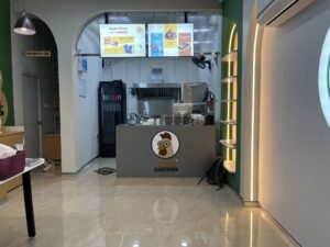 Koin Chicken acrylic logo on service counter front