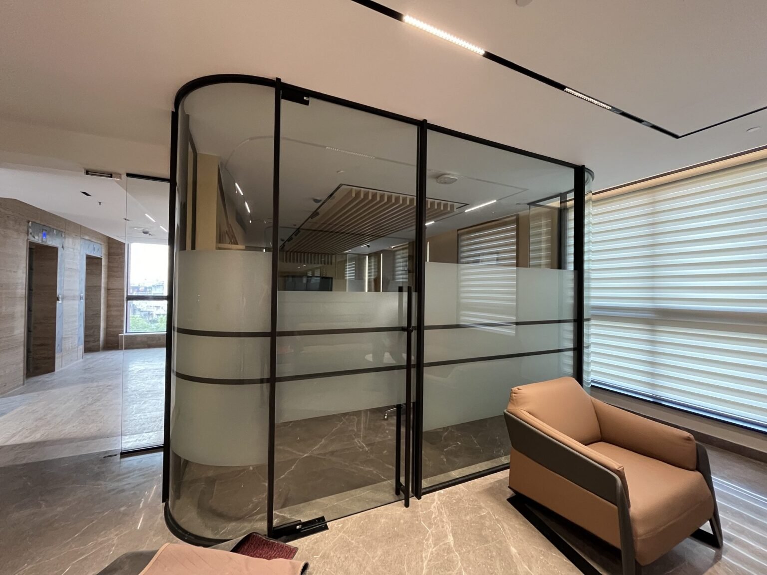 Framed glass office partition with frosted film banding