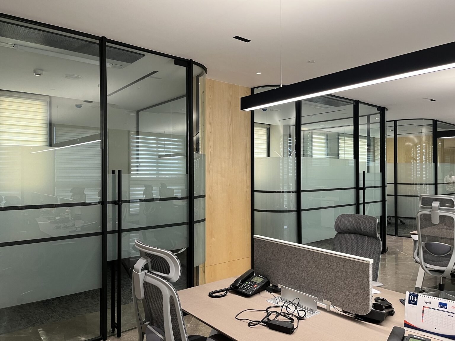 Framed glass office partition with frosted film banding