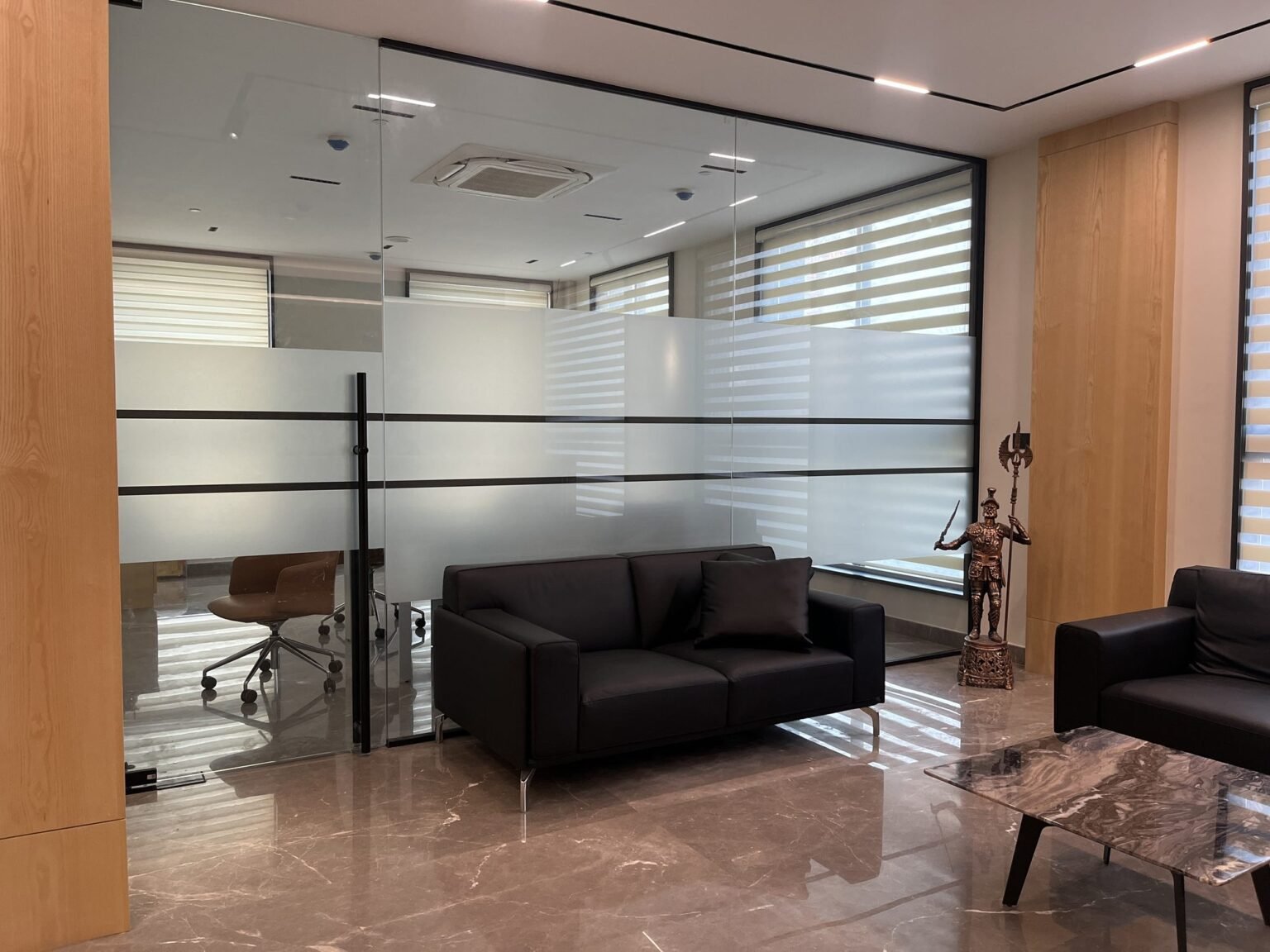 Framed glass office partition with frosted film banding