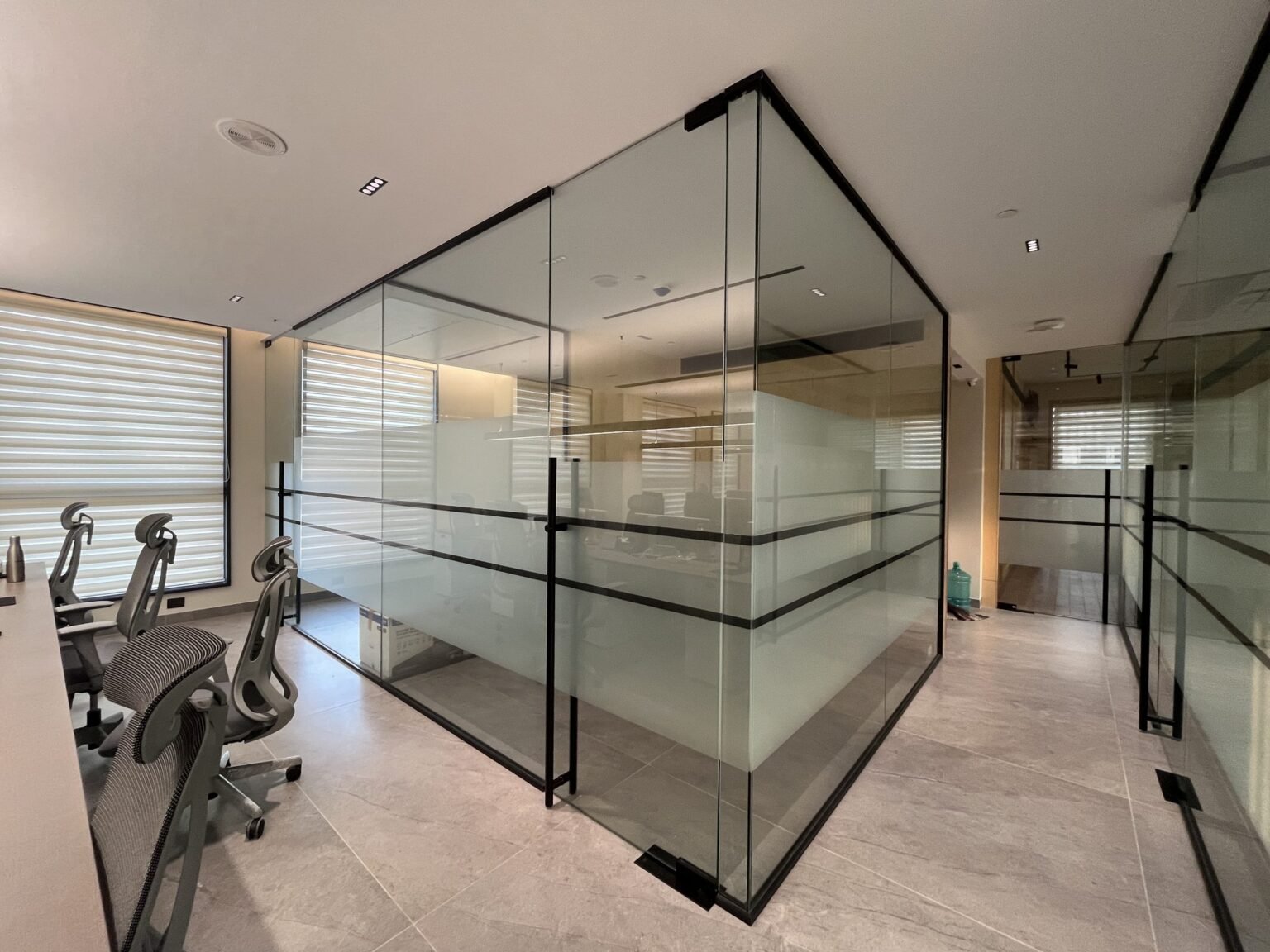 Framed glass office partition with frosted film banding