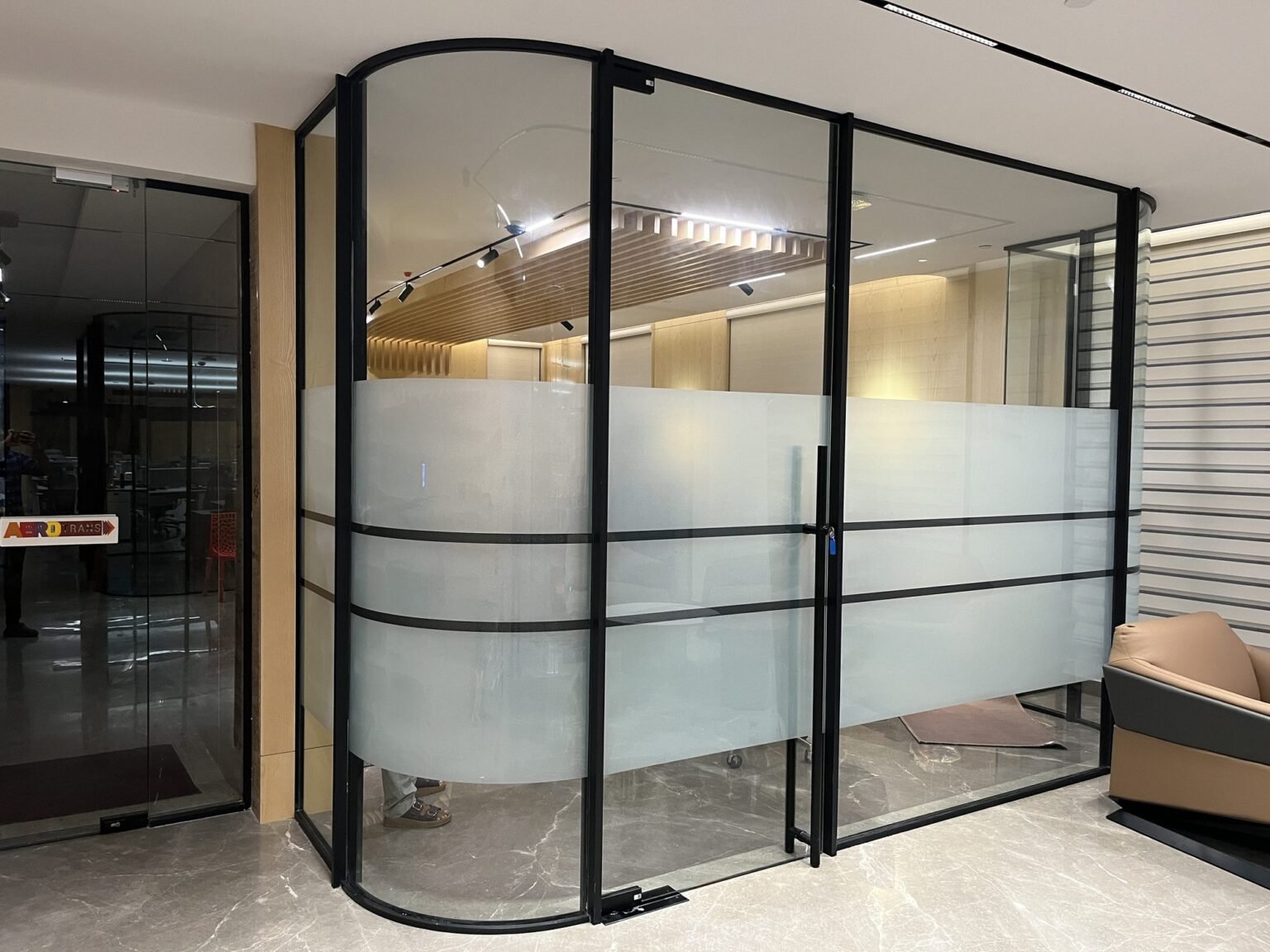 Framed glass office partition with frosted film banding