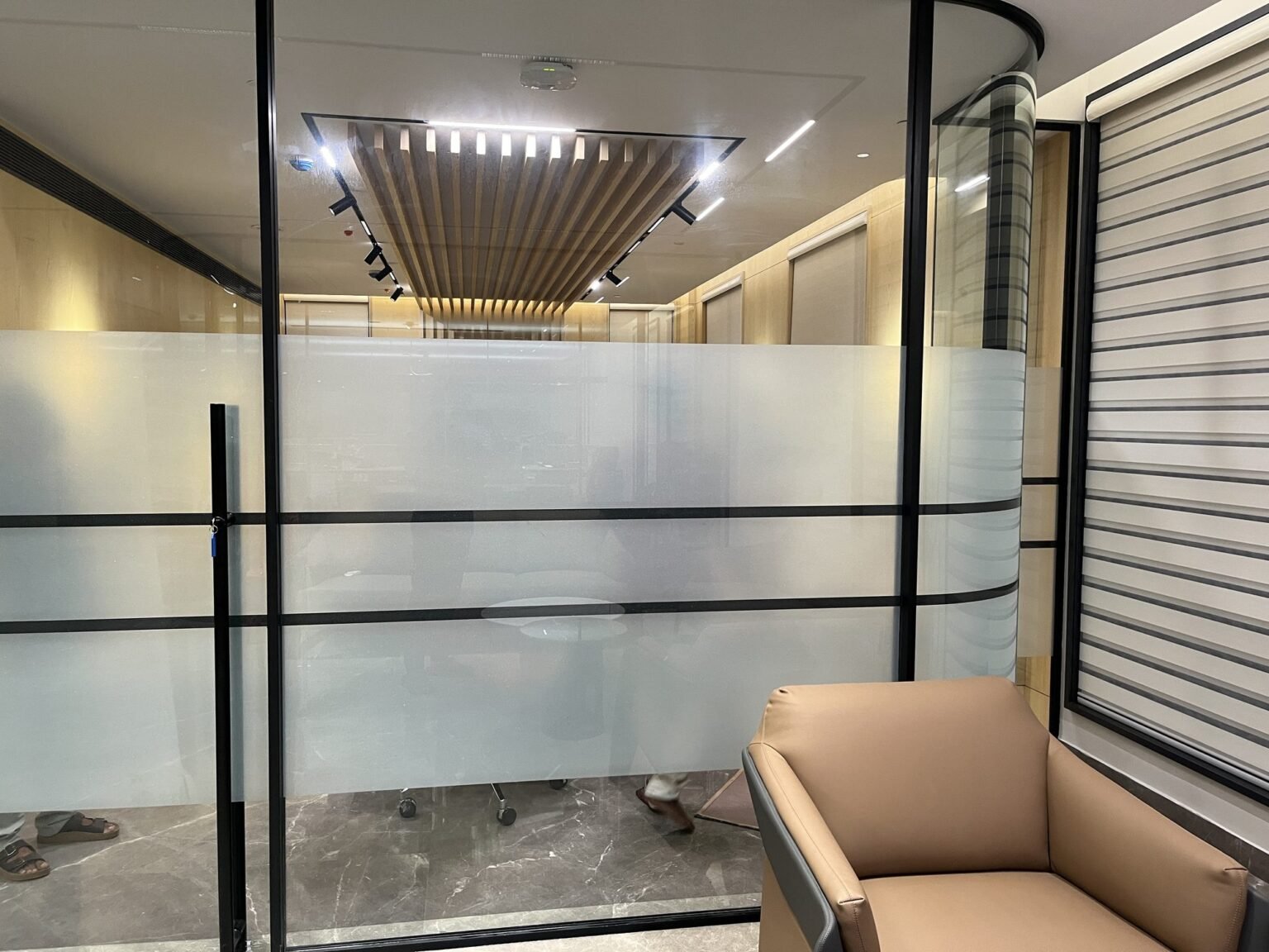 Framed glass office partition with frosted film banding
