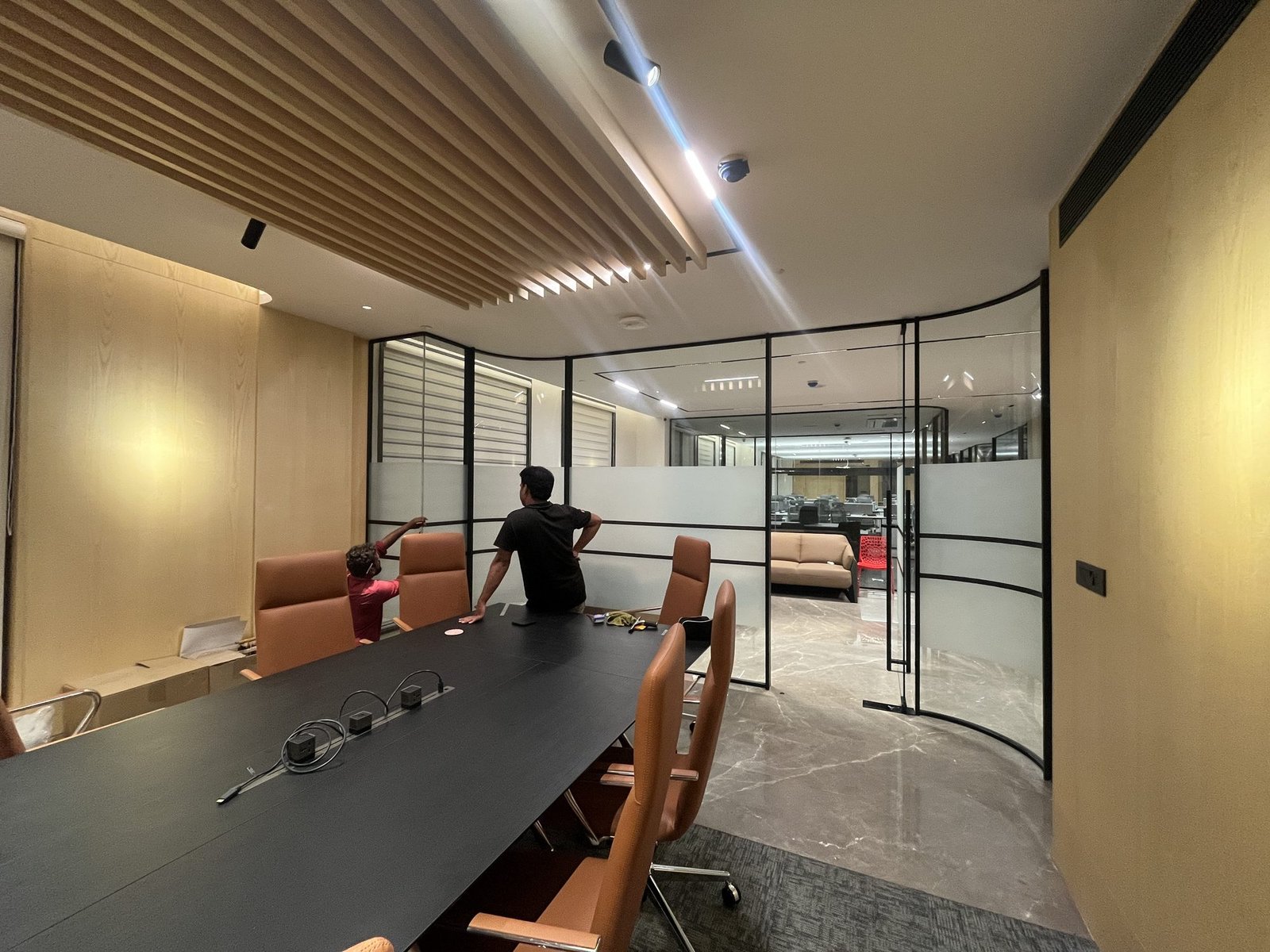 Meeting room enclosed in framed glass with frosted film banding