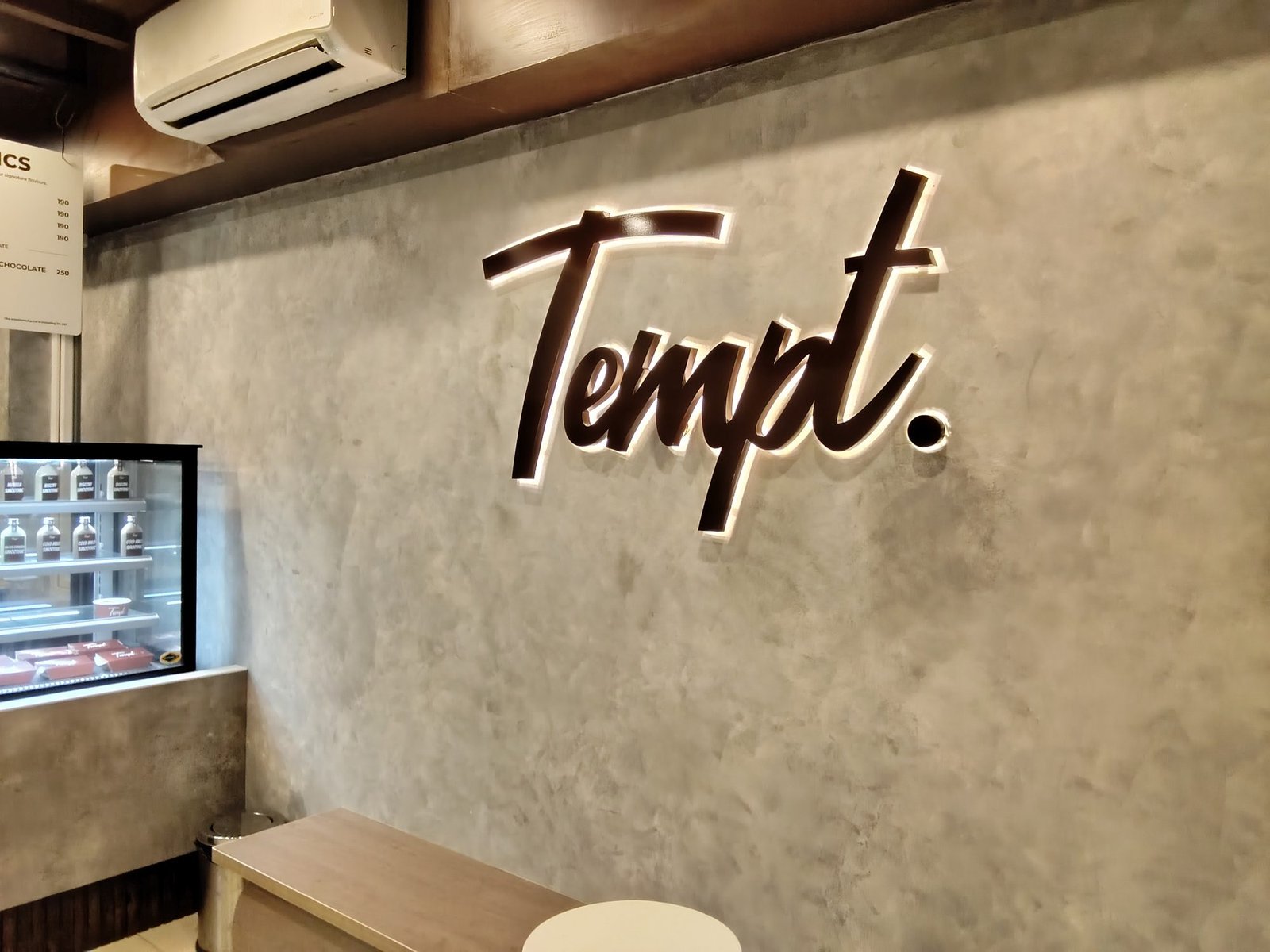Tempt. interior 3D letter signage above seating
