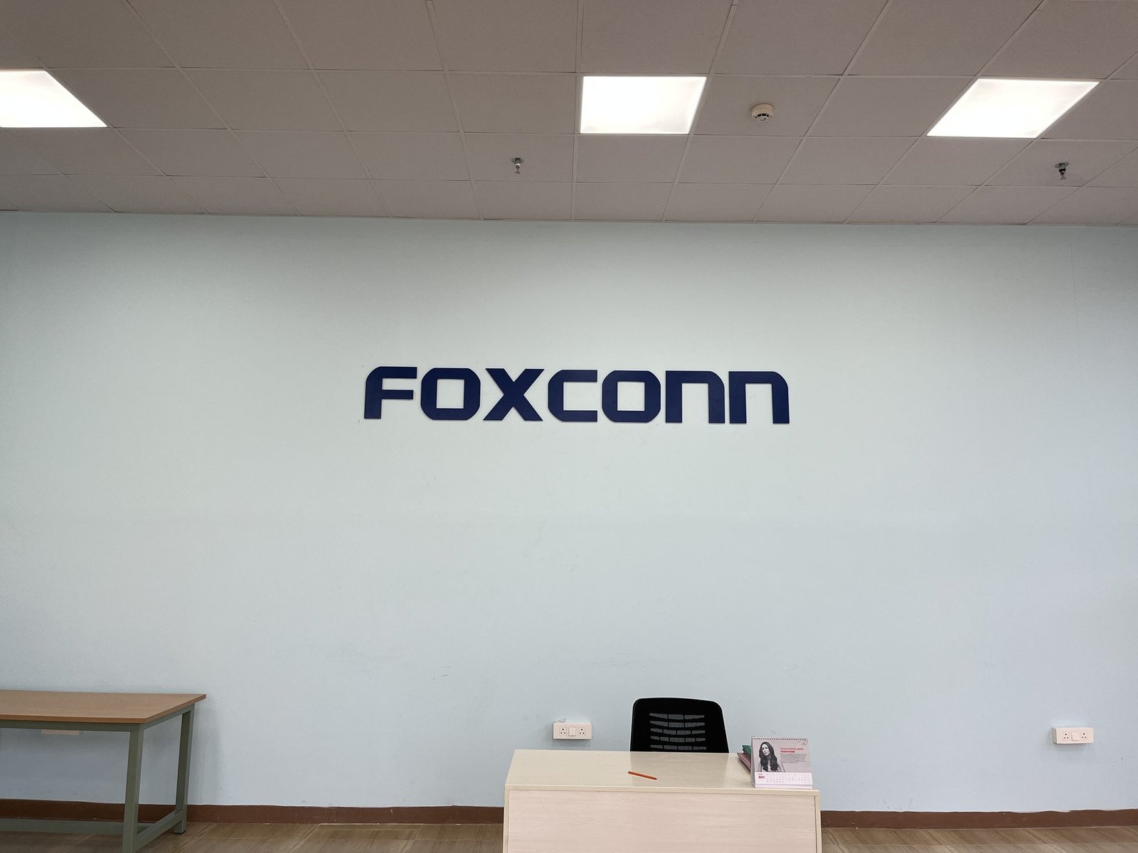 Foxconn reception wall lettering in brand blue