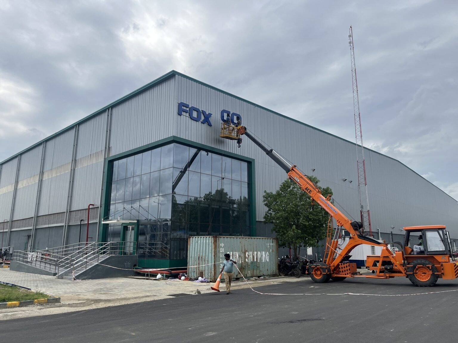 Installing Foxconn facade lettering at height by crane