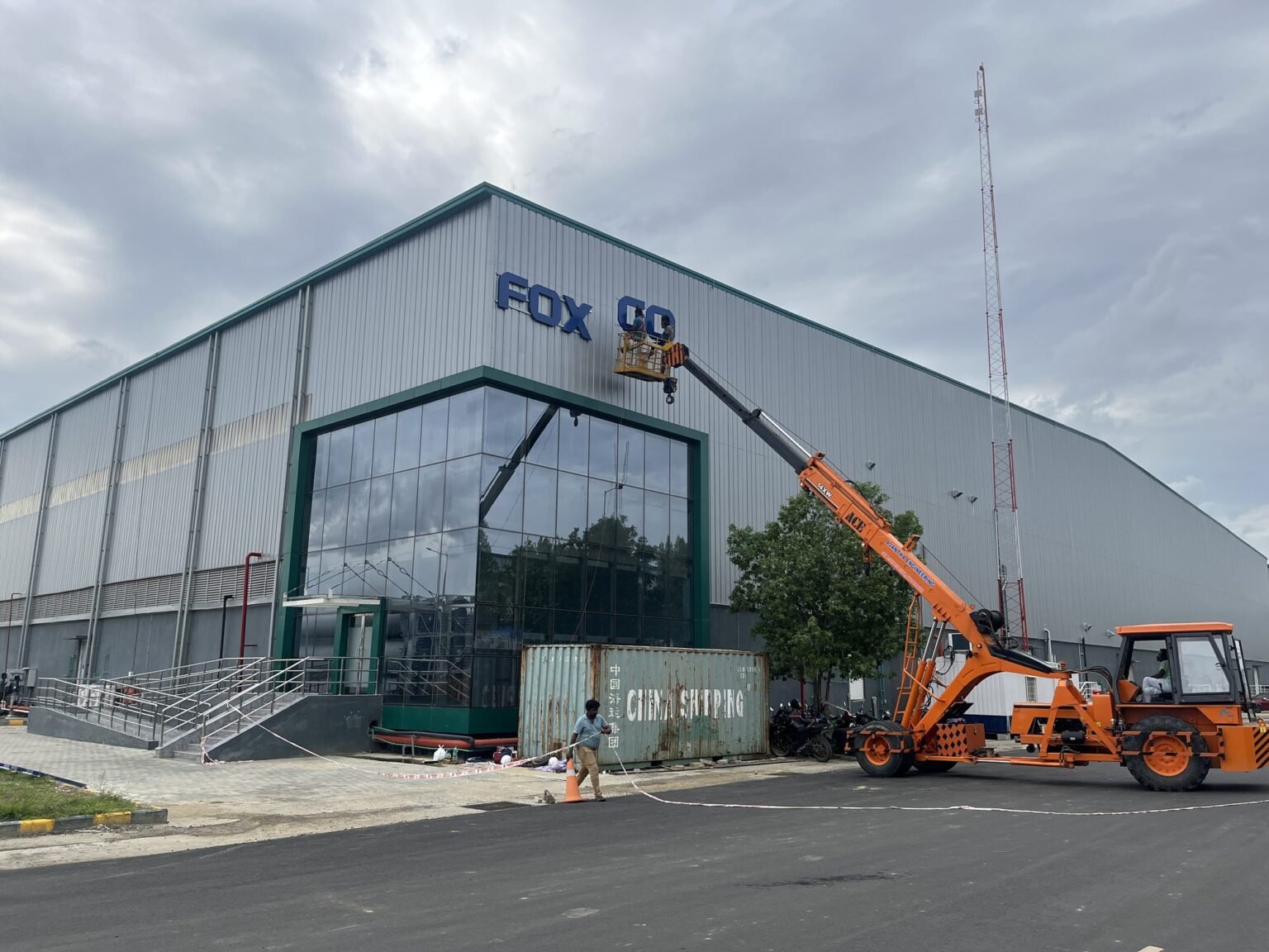 Installing Foxconn facade lettering at height by crane