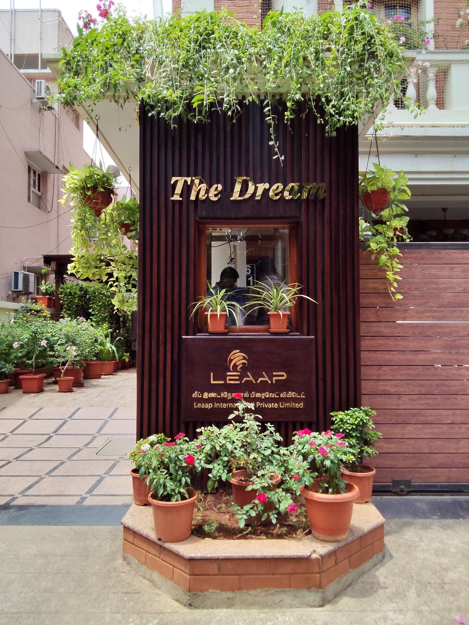 The Dream gold metal letters on dark timber entrance wall