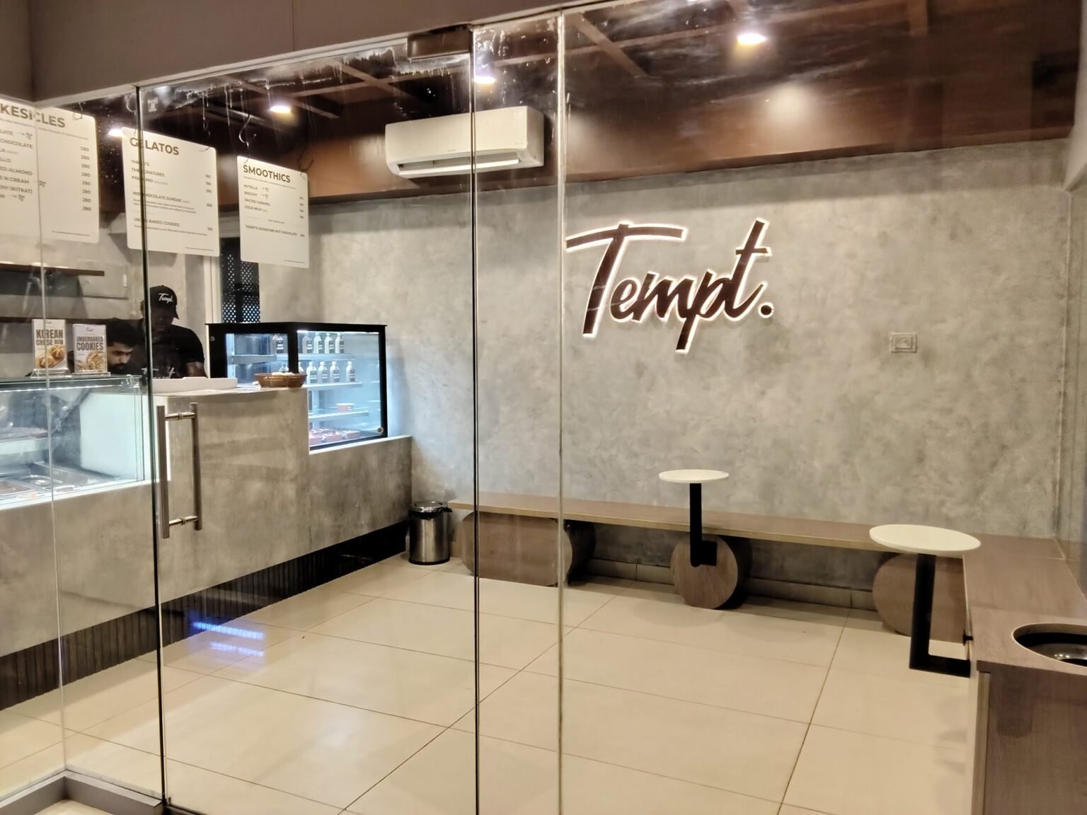 Tempt. interior lettering seen through the glass frontage