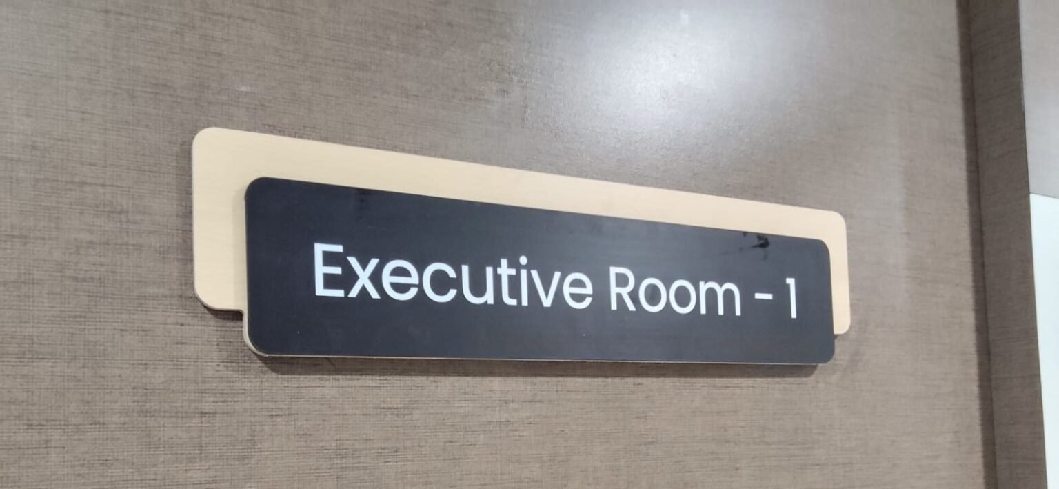 Executive Room signage on timber-clad corridor wall